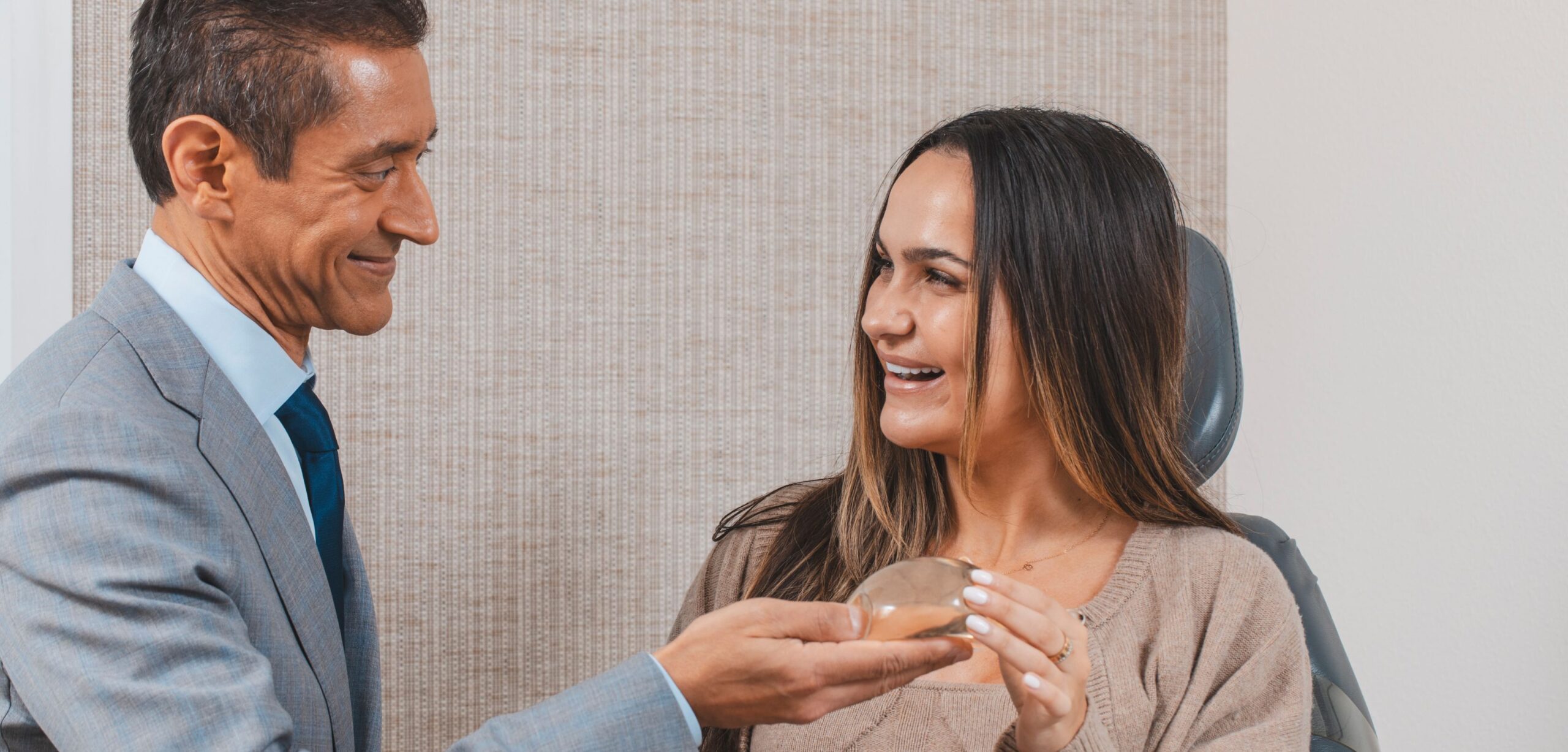 Dr. Savalia with a patient holding implant