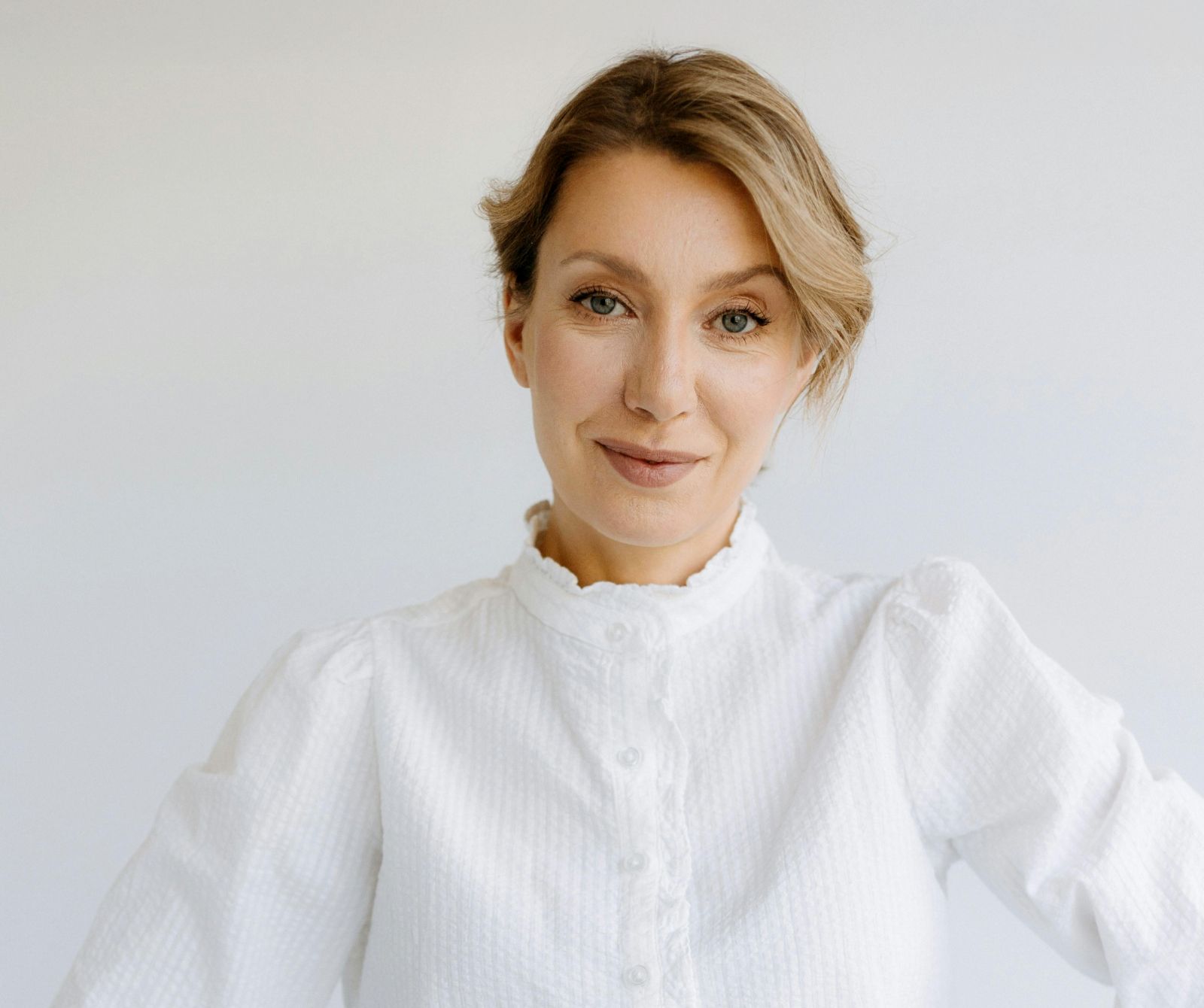 Woman wearing white button blouse