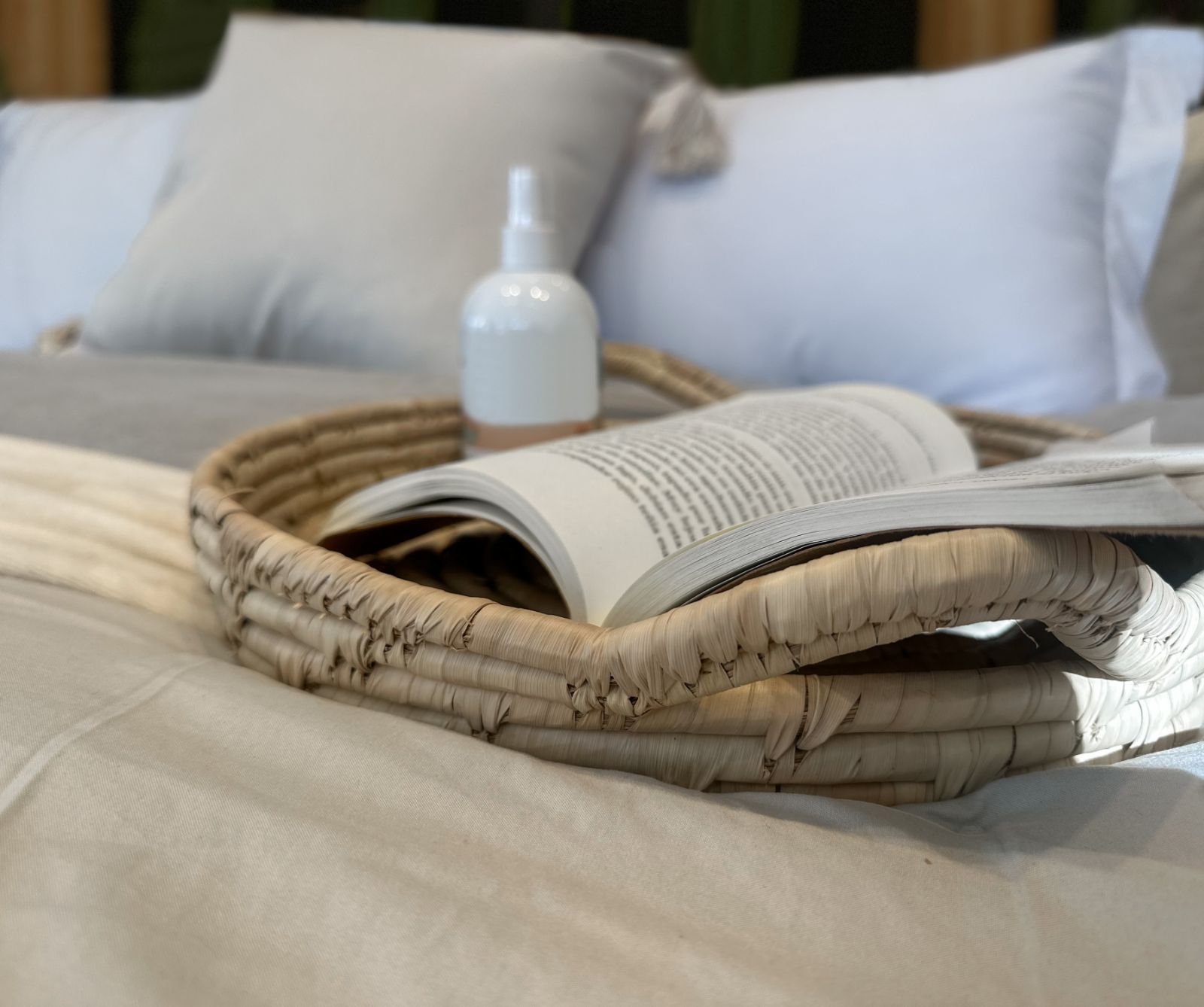 Book on a tray on a bed